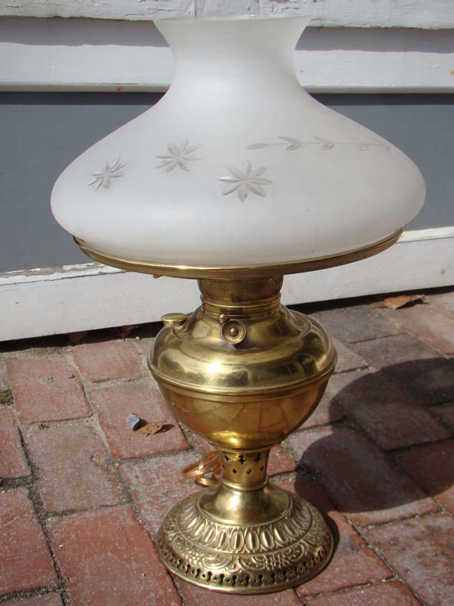 A late 19th century oil lamp with decorative etched glass shade circa 1880